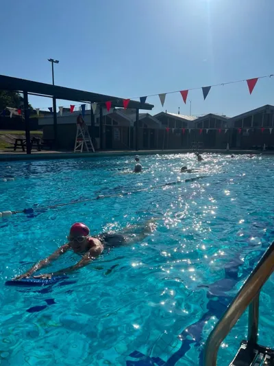 Swimmers using the outdoor heated pool at Teignmouth Lido on the Devon coast